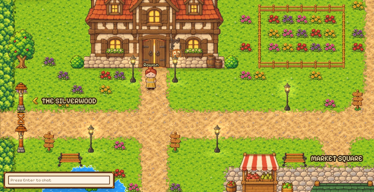 The capital in the game: the tavern with its red roof and lit windows, a fenced flower garden, a player at the tavern door, the signpost to the Silverwood and the first stalls of the Market Square.